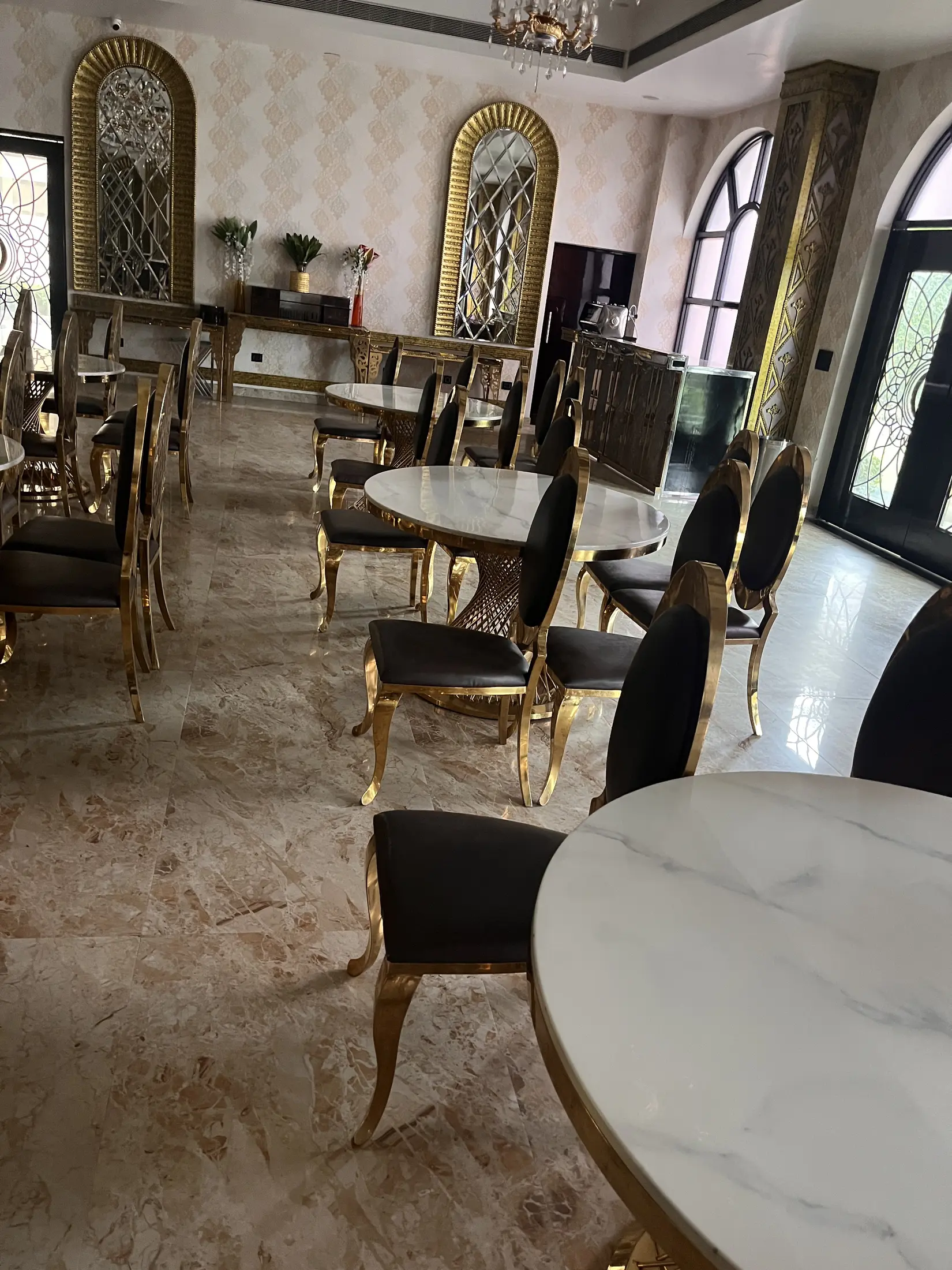Marble dining tables and decorative brass chairs