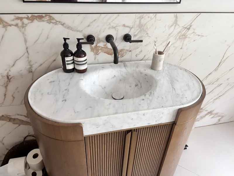 Hand-finished curved marble basin edge