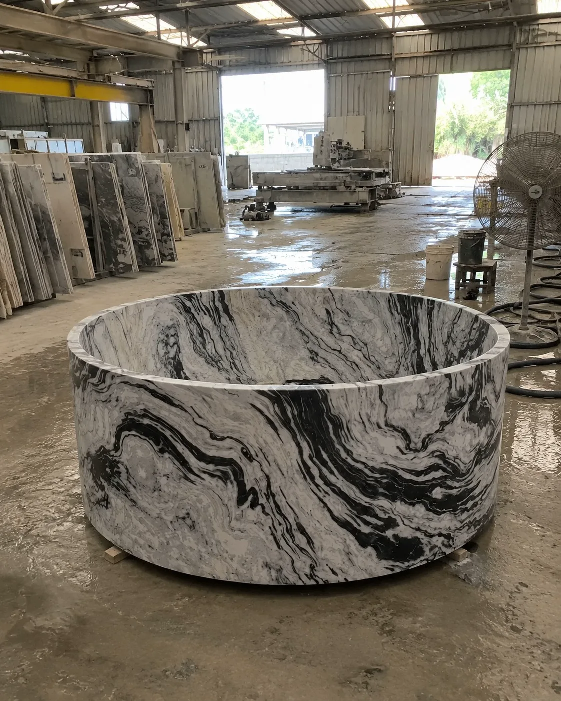 Single-block sculptural marble bath in the workshop
